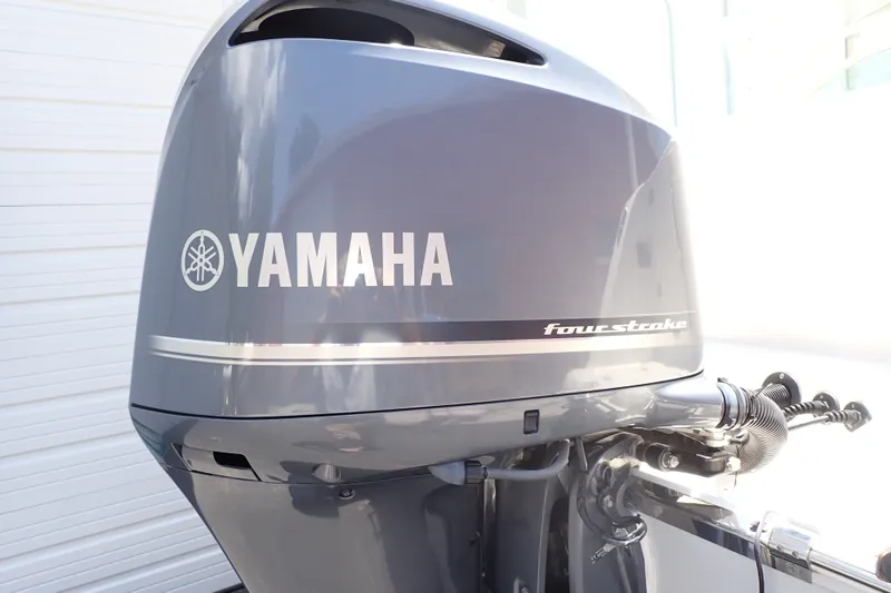 Slide: The Image of Yamaha four-stroke outboard motor on a 2019 Sailfish 245 DC boat. - 104