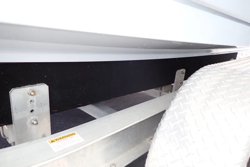 Slide: The Image of Trailer detail of 2019 Sailfish 245 DC boat, featuring metal frame and warning label. - 127