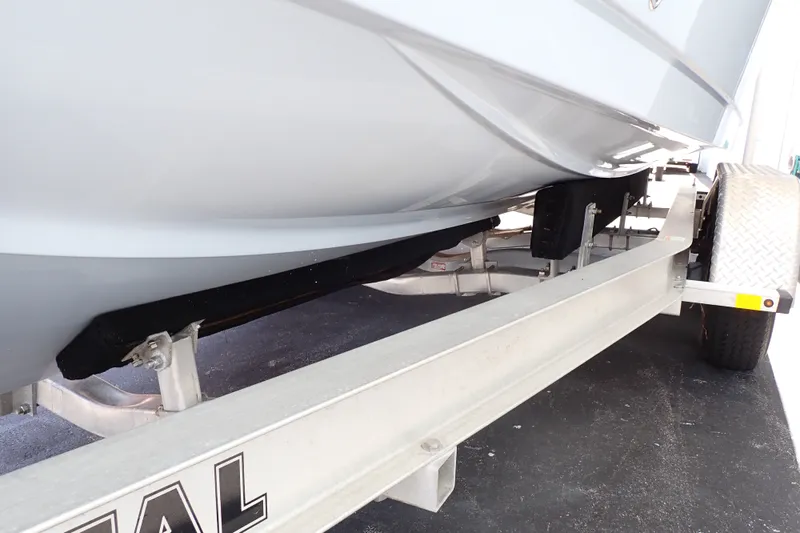 Slide: The Image of 2019 Sailfish 245 DC boat on a trailer, showcasing hull and trailer details. - 126