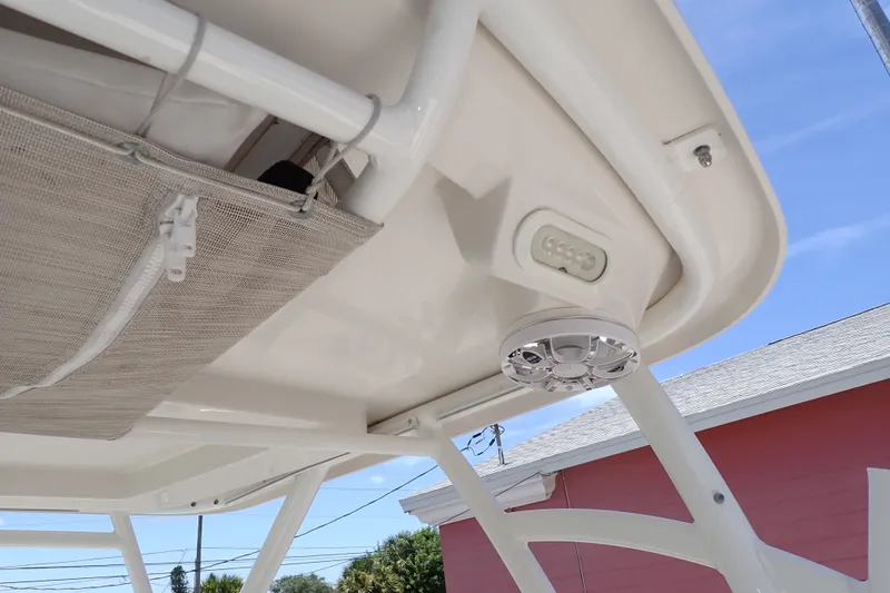 Slide: The Image of 2019 Sailfish 245 DC boat canopy with speaker and storage compartment. - 86
