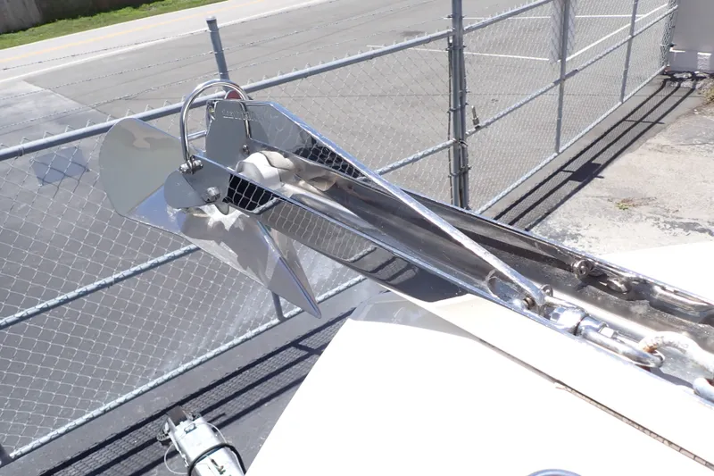 Slide: The Image of Stainless steel anchor on 2019 Sailfish 245 DC boat, docked near chain-link fence. - 41