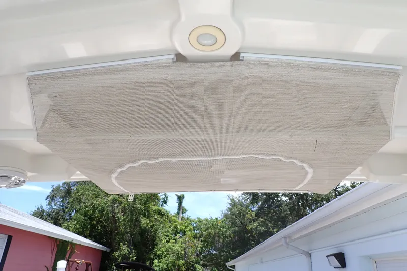 Slide: The Image of 2019 Sailfish 245 DC boat with a retractable sunshade canopy. - 88