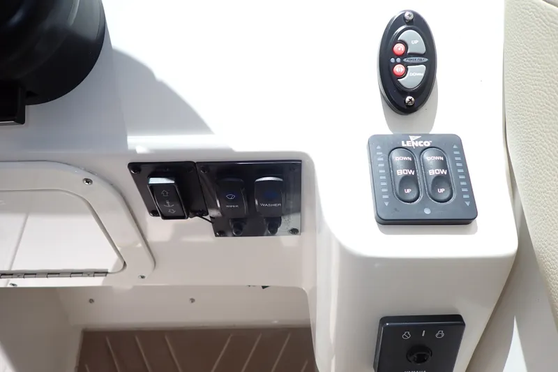 Slide: The Image of Control panel of a 2019 Sailfish 245 DC boat with Lenco trim tab switches. - 25