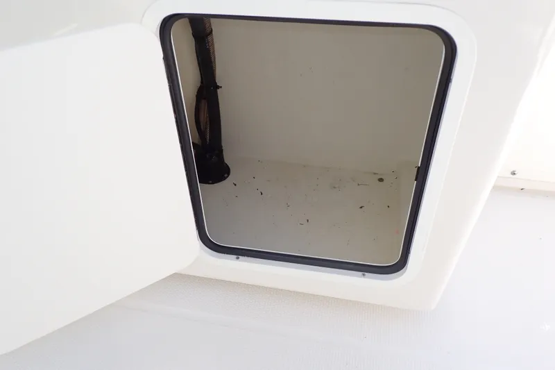 Slide: The Image of Open storage compartment on a 2019 Sailfish 245 DC boat. - 65