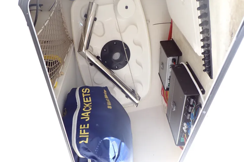 Slide: The Image of Storage compartment of 2019 Sailfish 245 DC boat with life jackets and equipment. - 15