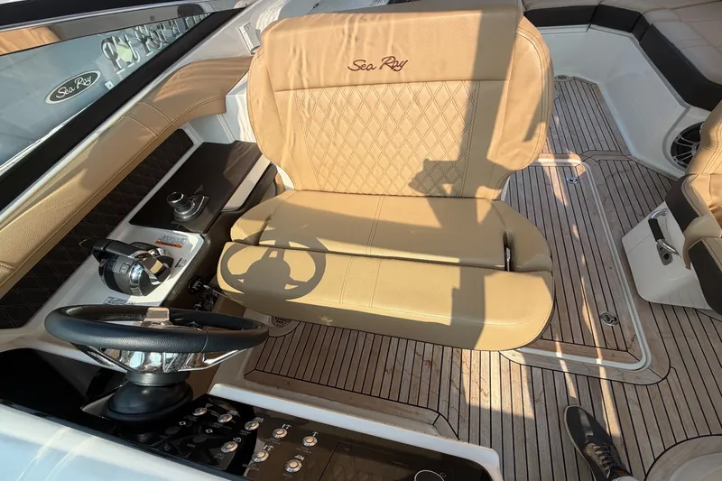 Slide: The Image of The image shows the interior of a 2020 Sea Ray SLX 310 Outboard with beige seating. - 18