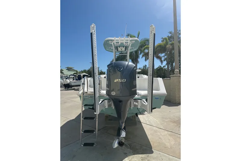 Slide: The Image of 2023 Tidewater 232 CC Adventure boat with powerful 250 engine, docked under clear blue sky. - 17