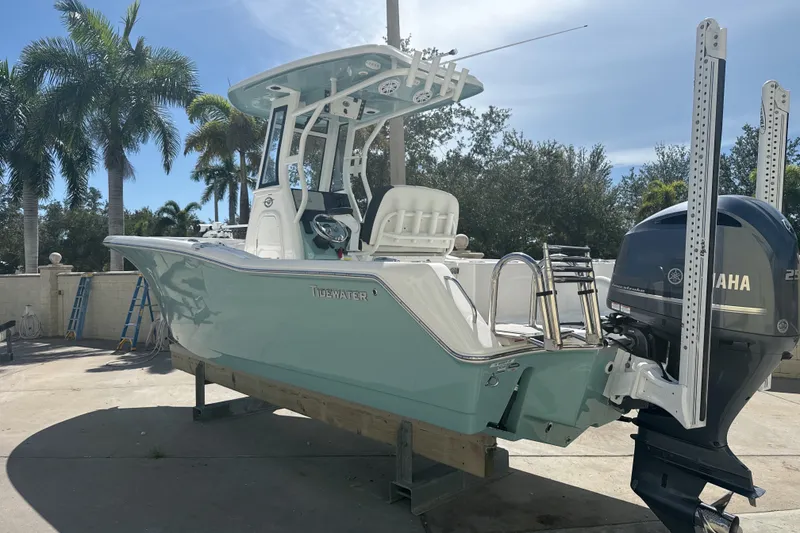 Slide: The Image of 2023 Tidewater 232 CC Adventure boat with Yamaha engine, parked outdoors. - 20