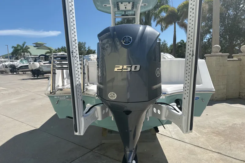 Slide: The Image of 2023 Tidewater 232 CC Adventure boat with Yamaha 250 engine in a sunny marina. - 18