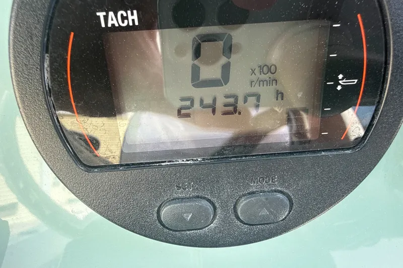 Slide: The Image of Tachometer display showing 243.7 hours on a 2023 Tidewater 232 CC Adventure boat. - 21