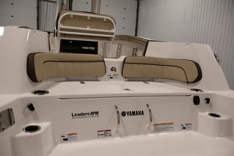 Slide: The Image of 2026 Yamaha Boats 252 FSH Sport interior with beige seating and cup holders. - 47