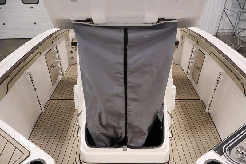 Slide: The Image of 2026 Yamaha Boats 252 FSH Sport interior with open storage compartment and sleek deck design. - 22