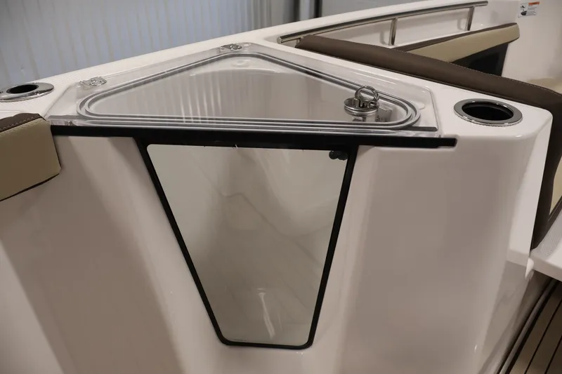 Slide: The Image of 2026 Yamaha Boats 252 FSH Sport interior detail with storage compartment and cup holders. - 16