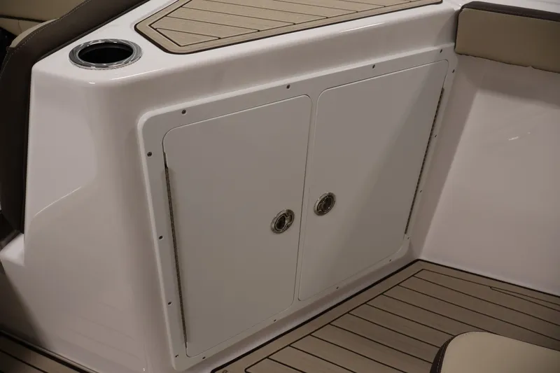 Slide: The Image of 2026 Yamaha Boats 252 FSH Sport interior storage compartment with sleek design and cup holder. - 18
