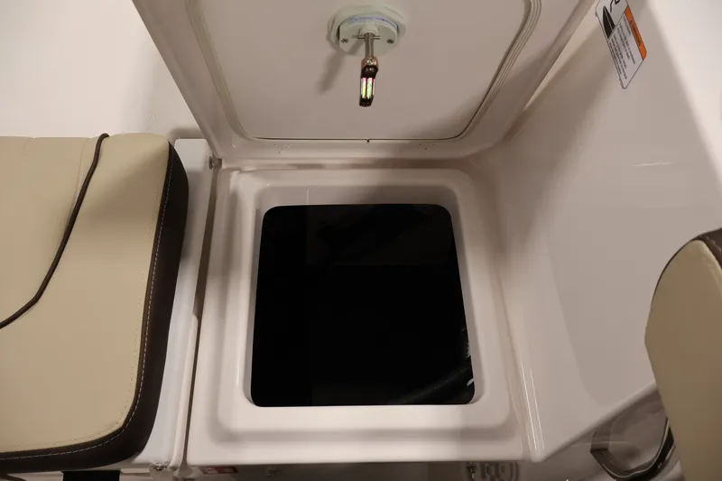 Slide: The Image of Open storage compartment on 2026 Yamaha Boats 252 FSH Sport, featuring beige seating. - 36