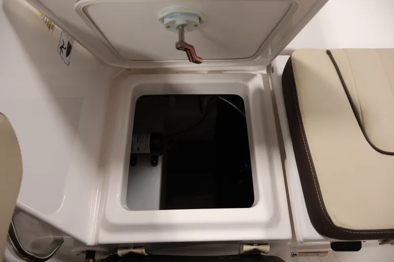 Slide: The Image of Open storage compartment on 2026 Yamaha Boats 252 FSH Sport, featuring beige seating. - 38