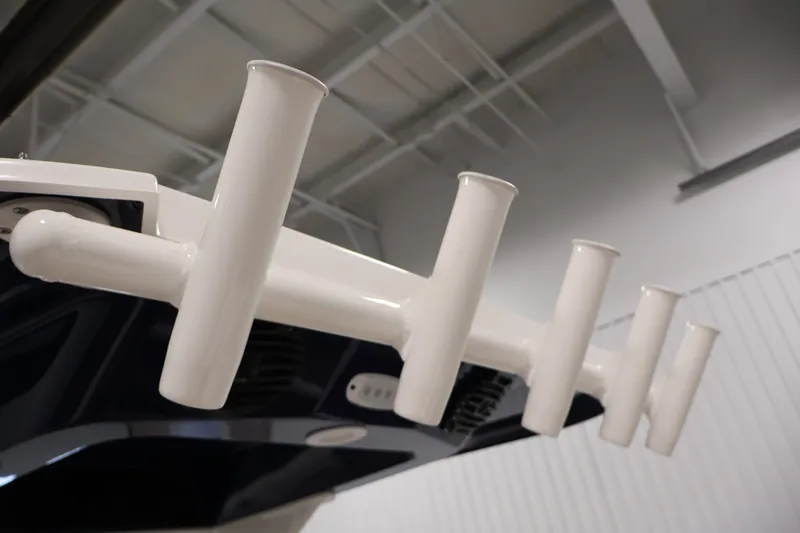 Slide: The Image of 2026 Yamaha Boats 252 FSH Sport rod holders in a sleek indoor setting. - 44