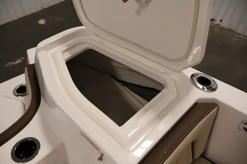 Slide: The Image of Open storage compartment on 2026 Yamaha Boats 252 FSH Sport, featuring cup holders and seating. - 40