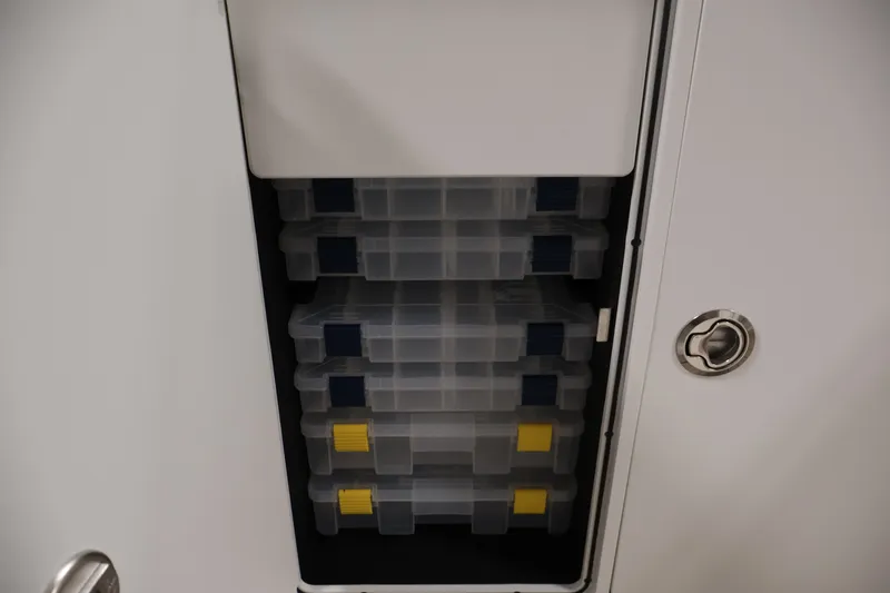 Slide: The Image of Storage compartment with tackle boxes on a 2026 Yamaha Boats 252 FSH Sport. - 19