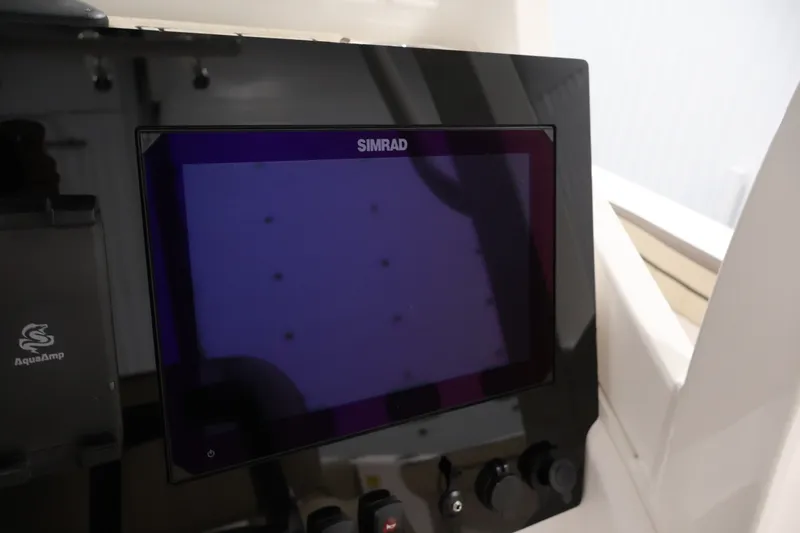 Slide: The Image of Simrad display on 2026 Yamaha Boats 252 FSH Sport dashboard, featuring AquaAmp system. - 29