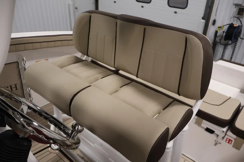 Slide: The Image of 2026 Yamaha Boats 252 FSH Sport interior with beige seating and steering wheel detail. - 33