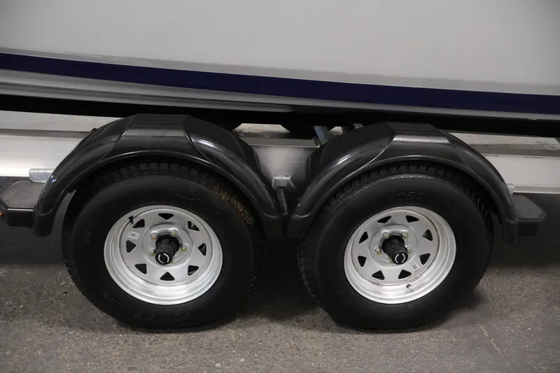 Slide: The Image of Trailer wheels of 2026 Yamaha Boats 252 FSH Sport, showcasing dual axle design. - 52