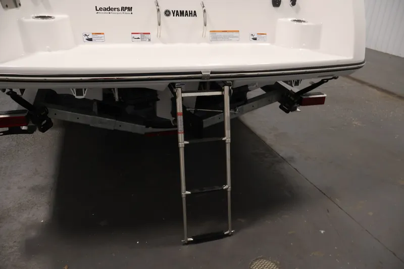 Slide: The Image of 2026 Yamaha Boats 252 FSH Sport rear view with ladder extended. - 48