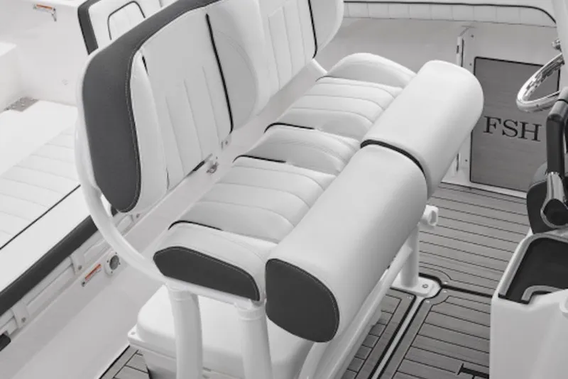 Slide: The Image of 2026 Yamaha Boats 252 FSH Sport interior seating, featuring sleek white and black upholstery. - 2