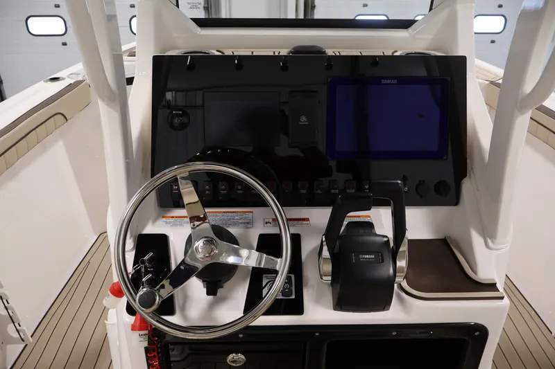 Slide: The Image of Helm of 2026 Yamaha Boats 252 FSH Sport, featuring steering wheel and control panel. - 26