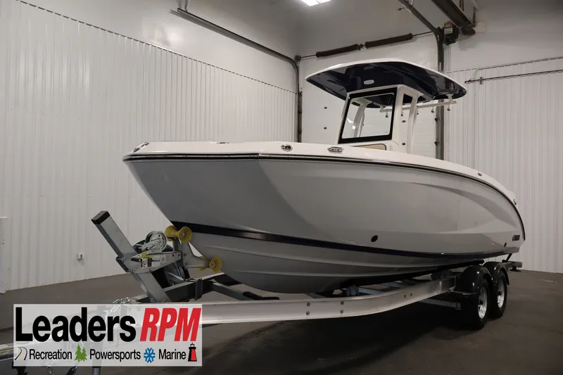 The Image of 2026 Yamaha Boats 252 FSH Sport on trailer in indoor showroom. - 0