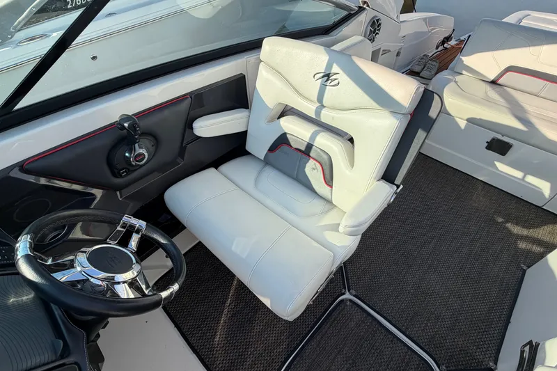 Slide: The Image of Interior of a 2014 Monterey 288SS Super Sport boat with white seating and steering wheel. - 15