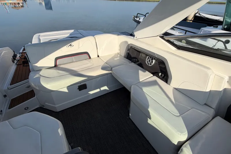 Slide: The Image of 2014 Monterey 288SS Super Sport boat interior with white seating and cup holders. - 22