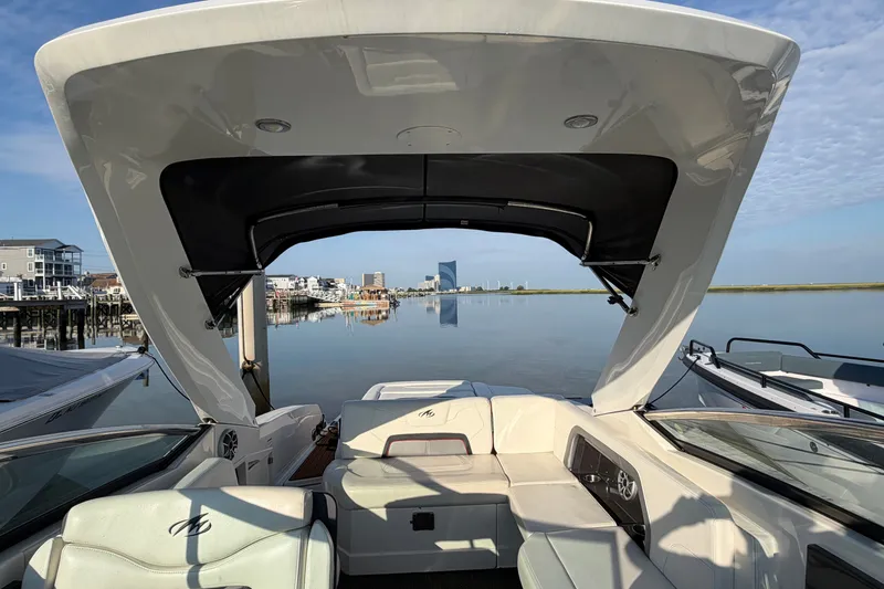 Slide: The Image of 2014 Monterey 288SS Super Sport boat docked with scenic waterfront view. - 23