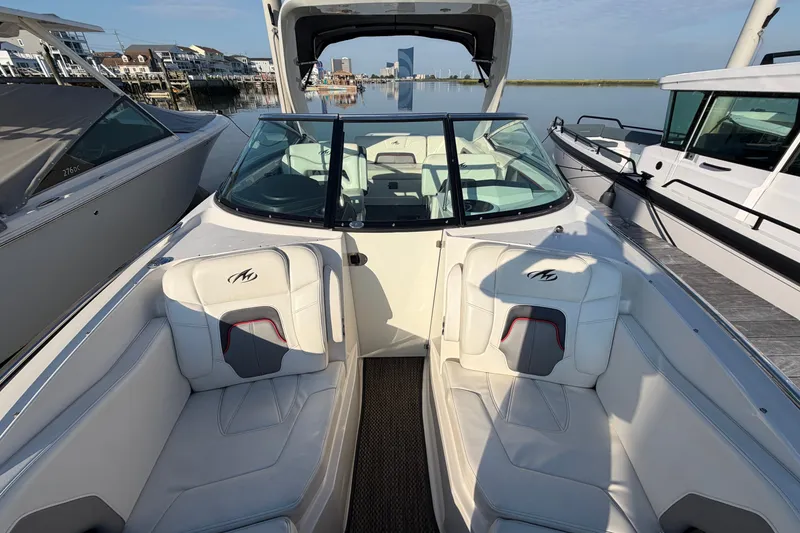 Slide: The Image of 2014 Monterey 288SS Super Sport boat interior with white seating, docked by the water. - 6