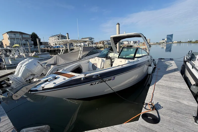 The Image of 2014 Monterey 288SS Super Sport boat docked at a marina under clear skies. - 0