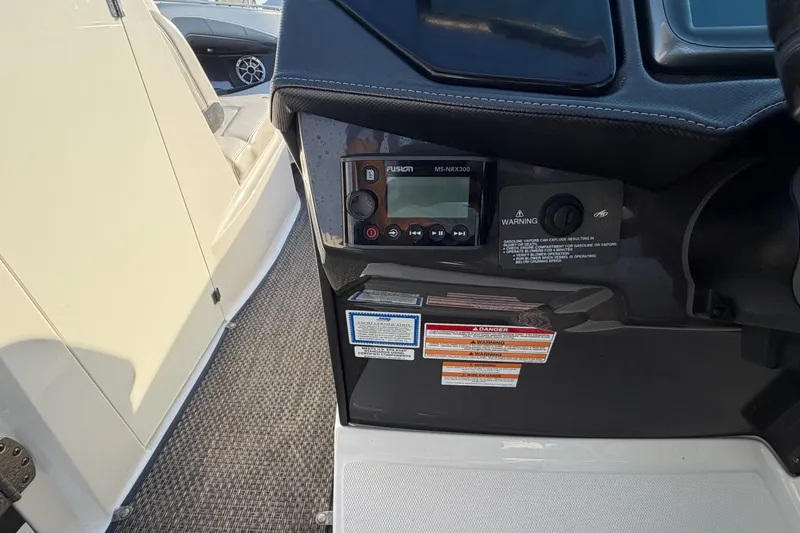 Slide: The Image of Control panel of a 2014 Monterey 288SS Super Sport boat with warning labels. - 13
