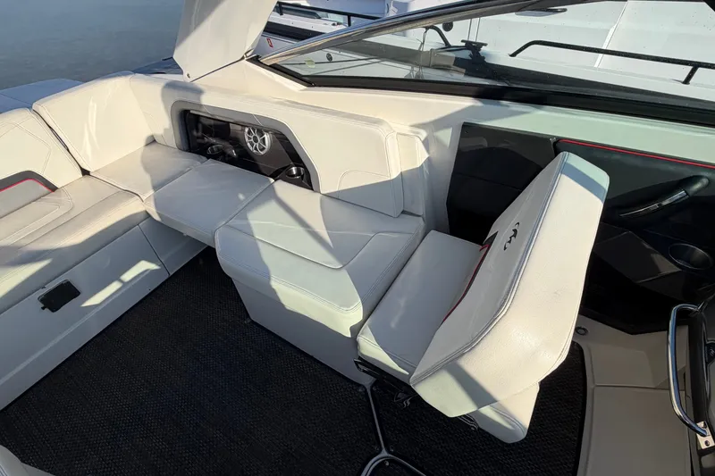 Slide: The Image of Interior of a 2014 Monterey 288SS Super Sport boat with white seating and speaker system. - 10