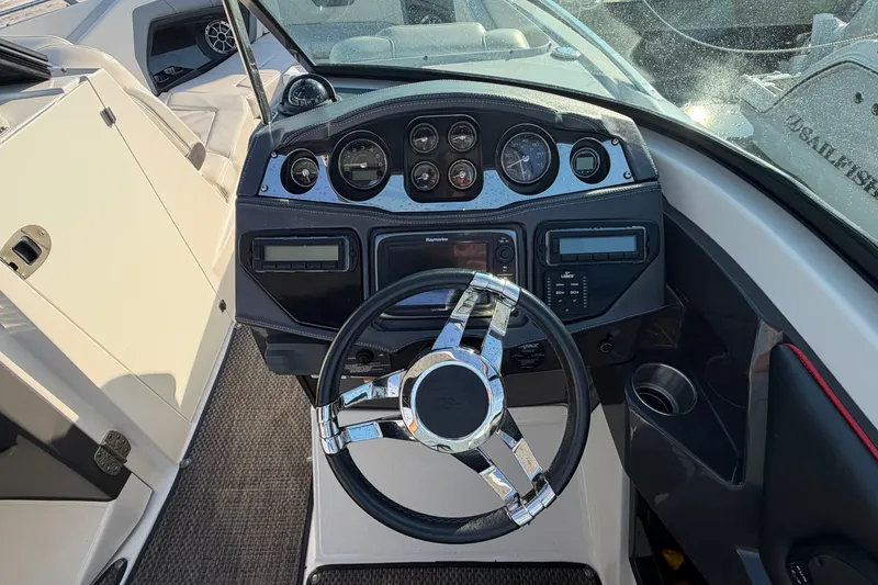 Slide: The Image of Dashboard of a 2014 Monterey 288SS Super Sport boat with steering wheel and gauges. - 12