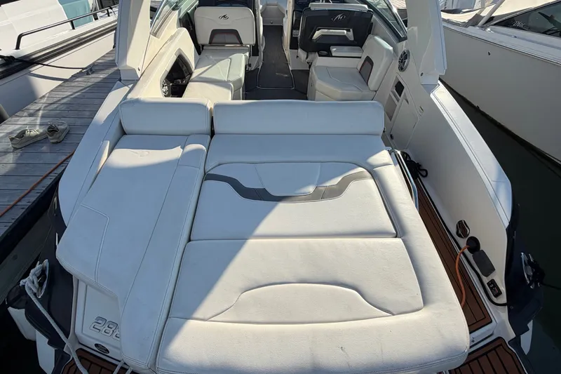 Slide: The Image of 2014 Monterey 288SS Super Sport boat interior with white seating and deck view. - 29