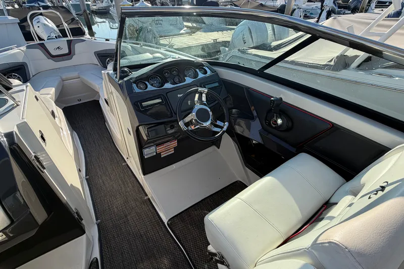 Slide: The Image of Interior of a 2014 Monterey 288SS Super Sport boat, featuring steering wheel and seating. - 11
