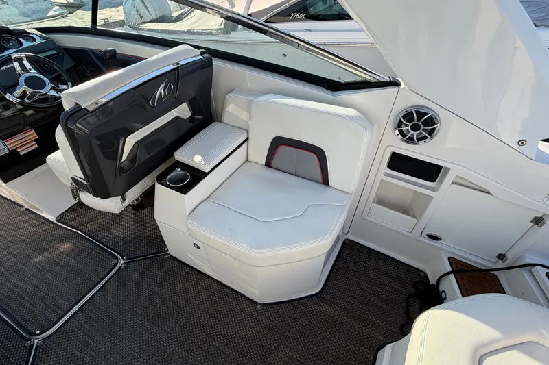 Slide: The Image of Interior of a 2014 Monterey 288SS Super Sport boat, featuring white seating and dashboard. - 18