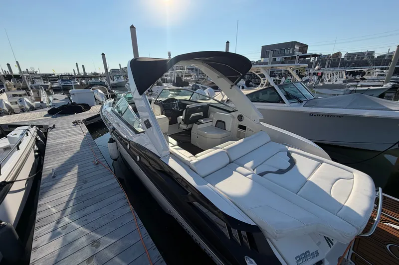 Slide: The Image of 2014 Monterey 288SS Super Sport boat docked at a marina under clear skies. - 2