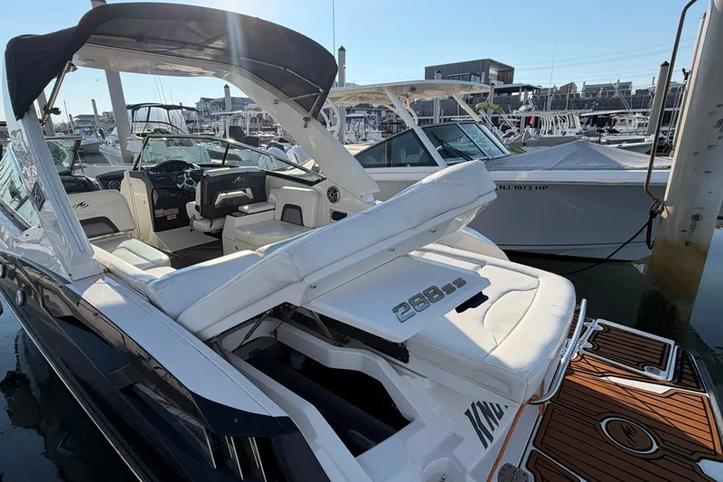 Slide: The Image of 2014 Monterey 288SS Super Sport boat docked at marina, featuring sleek design and spacious seating. - 31
