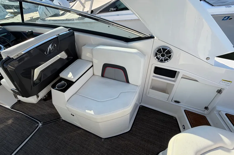 Slide: The Image of Interior of a 2014 Monterey 288SS Super Sport boat, featuring white seating and storage compartments. - 19