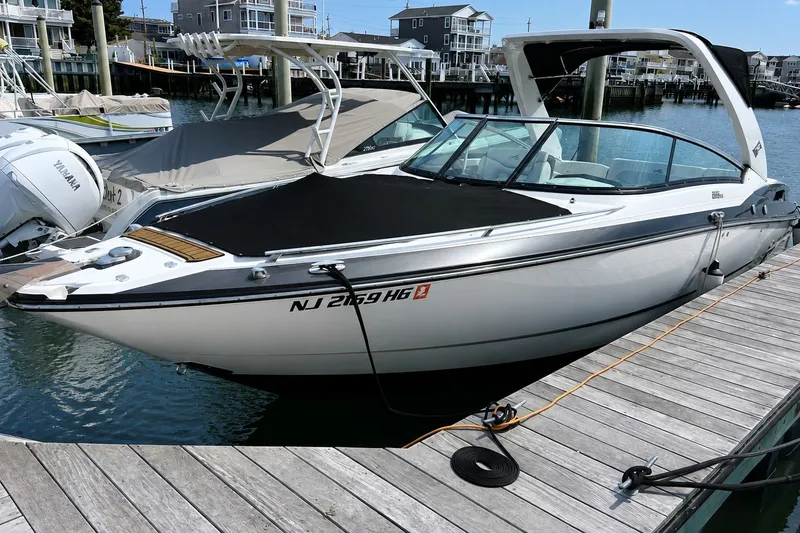 The Image of 2014 Monterey 288SS Super Sport boat docked at marina, sleek design, sunny day. - 1