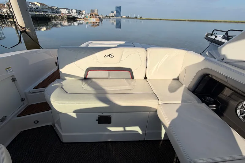 Slide: The Image of 2014 Monterey 288SS Super Sport boat interior with white seating and waterfront view. - 25