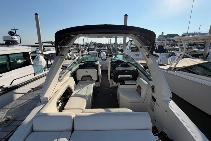 Slide: The Image of 2014 Monterey 288SS Super Sport boat interior at marina, featuring seating and helm. - 32