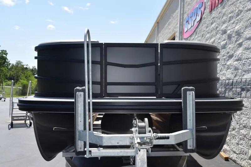 Slide: The Image of 2026 Evotti 523QL pontoon boat on trailer, parked outside a building. - 3
