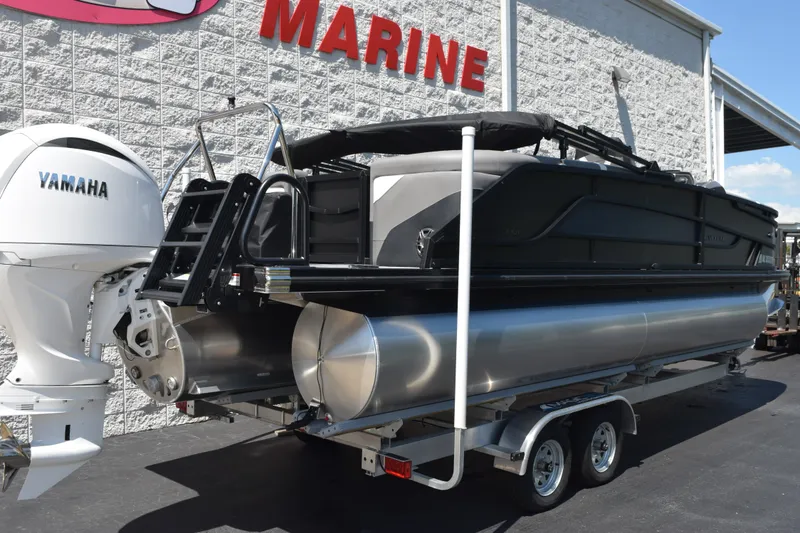 Slide: The Image of 2026 Evotti 523QL pontoon boat with Yamaha engine, displayed at a marine dealership. - 4