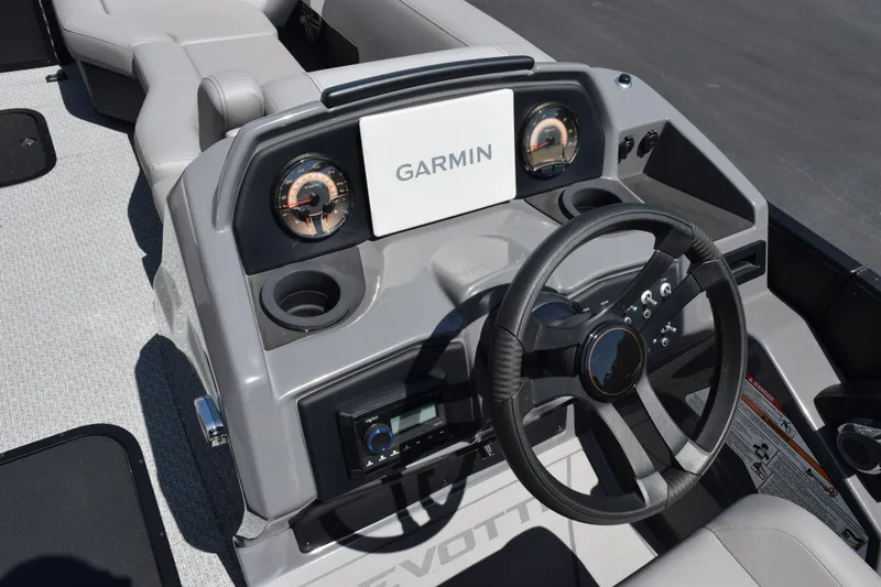 Slide: The Image of Steering console of 2026 Evotti 523QL boat with Garmin display and gauges. - 11